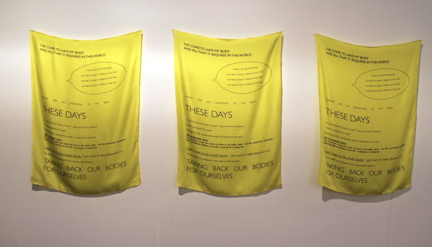 It's easy to miss Laura Aldridge's scarves, nondescript and tucked around the corner from Glasgow's Kendall Koppe. But they're well worth some time. They're a feminist manifesto to fat, on yellow silk scarves which faintly ripple in the breeze. 