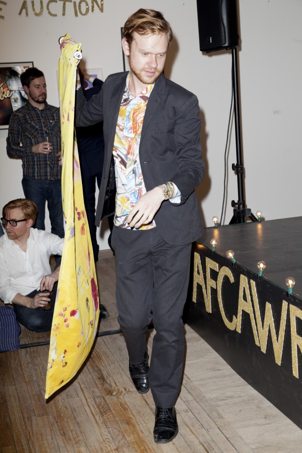 Matthew Leifheit delivers a Petra Cortright to the stage for auctioning