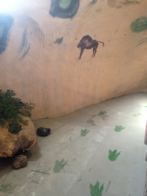 Inside the T-Rex, cave paintings appear alongside Creationist teachings.