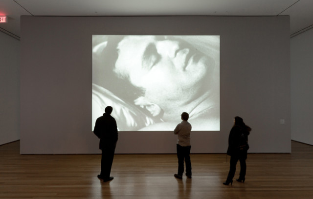 Installation view of Andy Warhol's "Sleep" at MoMA. The film shows artist John Giorno sleeping for nearly eight hours. Image courtesy of MoMA.
