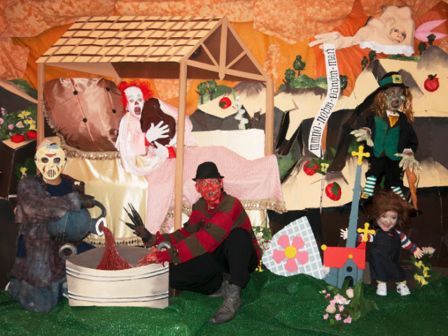 Jaimie Warren, "Self-portrait as Pennywise the Clown with the Blob, Jason, Freddy, Chucky, Leprechaun and Basketcase in re-creation of the Nativity scene from the Vyššì Brod Altarpiece (1350)," 2014