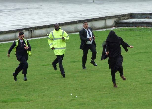 The grim reaper is chased around the grounds of an arms fair.