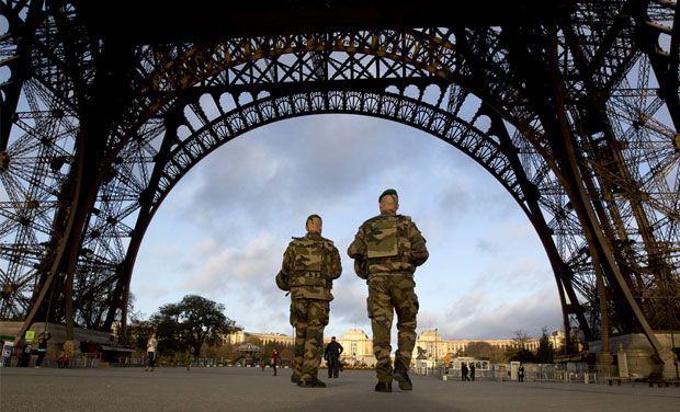 French soldiers guard the Eiffel Tower which remained closed on the first of three days of national mourning in Paris. Image via: Deccan Chronicle
