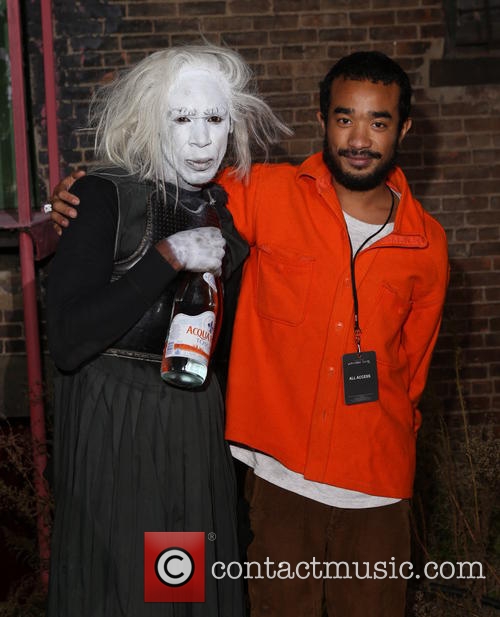 Artist Lucien Smith with a party guest. WAS HER COSTUME "SPECTER OF WHITE GENTRIFIERS"? Probably.