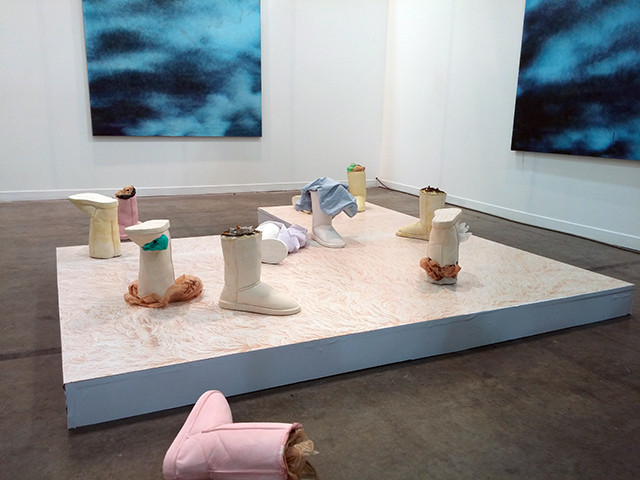 In the same row, a presentation by the gallery DUVE Berlin set Debora Delmar's casts of Ugg Boots filled with trash against stormy paintings by Ivan Comas. It's a dystopian nightmare, like the surface of Earth in "The Matrix" if all that survived of humanity was our worst fashion choices. 