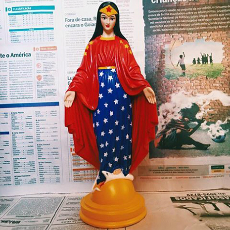 Brazilian artist, Ana Smile, has created a bit of controversy for painting religious plaster statues into pop culture figures like Wonder Woman. Credit: Dangerous Minds