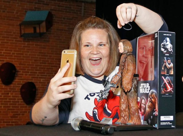 IMAGE DISTRIBUTED FOR HASBRO - Candace Payne, also known as Chewbacca Mom, streams a Facebook Live video with her custom Chewbacca Mom action figure during a meet and greet at Hasbro HQ in Pawtucket, R.I., Friday, June 17, 2016. Payne is known for her viral Facebook Live video post of herself wearing a Hasbro Chewbacca Electronic Mask. (Stew Milne/AP Images for Hasbro)