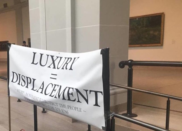 "Luxury = Displacement" at the MTOPP Booth in the Brooklyn Museum's third floor atrium