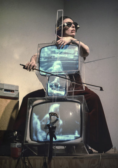 Charlotte Moorman performing on Nam June Paik’s TV Cello wearing TV Glasses, Bonino Gallery, New York City, 1971, Photo: Takahiko Iimura. © Takahiko Iimura