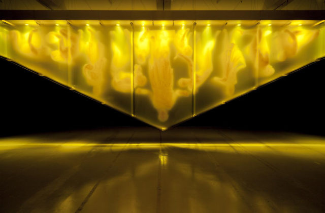 David Spriggs, Gold, 2017, yellow acrylic paint on layered sheets of transparent film, triangular gold color structure, lighting units (Photo by David Spriggs)