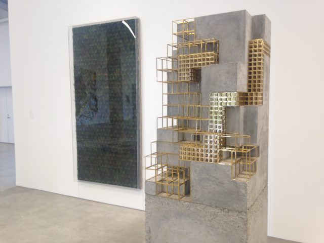 Carol Bove, "Untitled," Peacock feathers on linen, plexiglass vitrine, 2012 and "Peel's foe, not a set animal, laminates a tone of sleep," brass and concrete, 2013. 